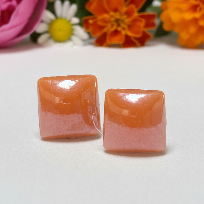 Pair of 8mm handmade square geometric stud earrings crafted from vibrant tangerine orange recycled glass pearlized tiles with hypoallergenic stainless steel posts.