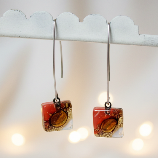 Open oval wire with handmade in red, soft lavender and brown recycled glass beads.