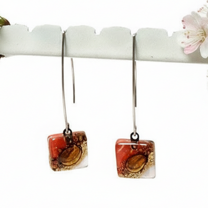 Open oval wire with handmade in red, soft lavender and brown recycled glass beads.