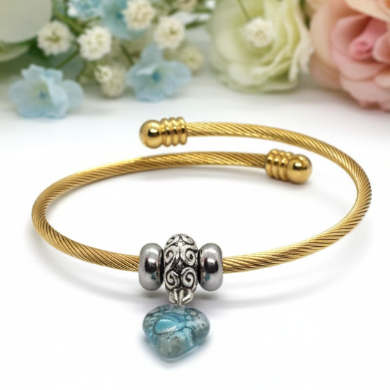 Aqua Blue Twisted Stainless Steel Bracelet Glass Charm Bead. Easy to put on expandable memory wire cuff. One size fits most