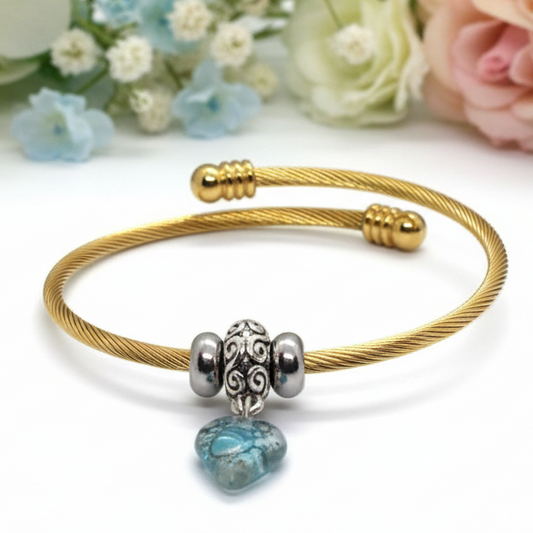 Aqua Blue Twisted Stainless Steel Bracelet Glass Charm Bead. Easy to put on expandable memory wire cuff. One size fits most