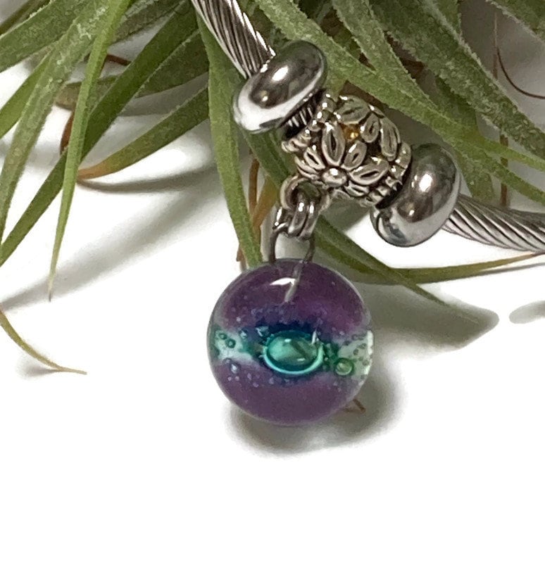 Purple and green Stainless Steel Bracelet Glass Charm Bead. Easy to put on adjustable stretch memory wire. One size fits most