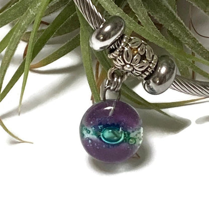 Purple and green Stainless Steel Bracelet Glass Charm Bead. Easy to put on adjustable stretch memory wire. One size fits most
