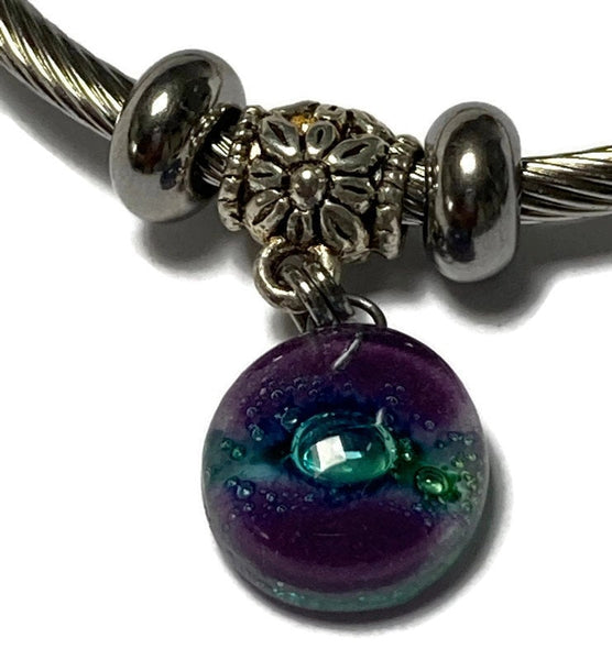 Purple and green Stainless Steel Bracelet Glass Charm Bead. Easy to put on adjustable stretch memory wire. One size fits most