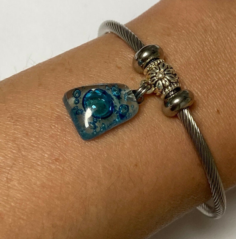 Turquoise with bubbles Stainless Steel Bracelet Glass Charm Bead. Easy to put on adjustable stretch memory wire. One size fits most