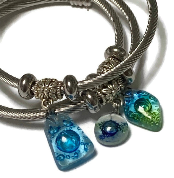 Turquoise with bubbles Stainless Steel Bracelet Glass Charm Bead. Easy to put on adjustable stretch memory wire. One size fits most