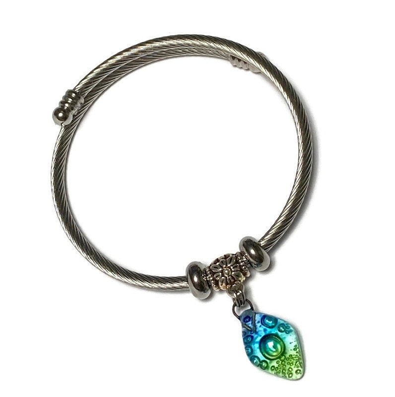 Turquoise, green and blue Stainless Steel Bracelet Glass Charm Bead. Easy to put on adjustable stretch memory wire. One size fits most.