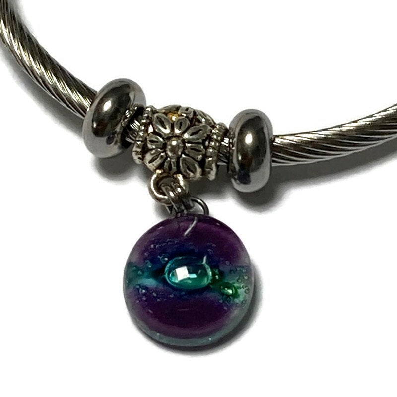 Purple and green Stainless Steel Bracelet Glass Charm Bead. Easy to put on adjustable stretch memory wire. One size fits most