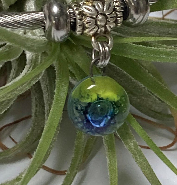 Green and blue Stainless Steel Bracelet Glass Charm Bead. Easy to put on adjustable stretch memory wire. One size fits most. Elastic