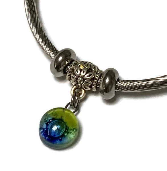 Green and blue Stainless Steel Bracelet Glass Charm Bead. Easy to put on adjustable stretch memory wire. One size fits most. Elastic