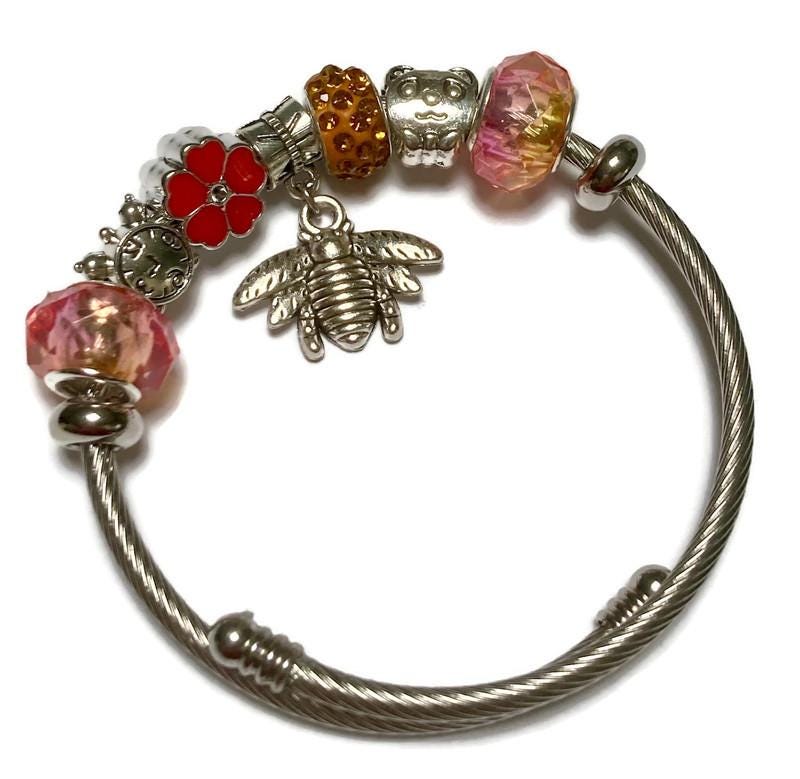 Pink, red and orange. Stainless Expandable Easy to put on stretch memory wire Charm Bracelet. One size fits most