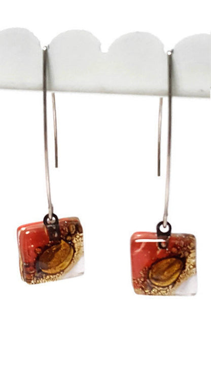 Open oval wire with handmade in red, soft lavender and brown recycled glass beads.