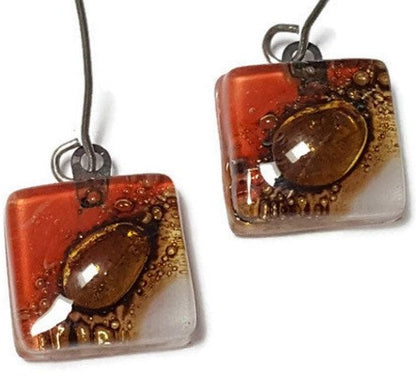 Open oval wire with handmade in red, soft lavender and brown recycled glass beads.