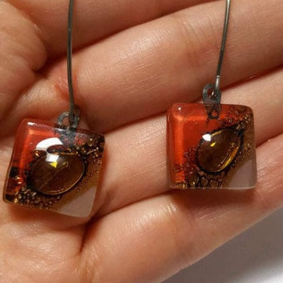 Open oval wire with handmade in red, soft lavender and brown recycled glass beads.