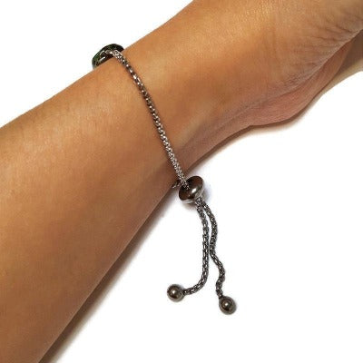 Minimalist, Dainty, Pull Tie bracelet. Adjustable slider bracelet with recycled glass charm. Stainless Steel. Organic brown green color.